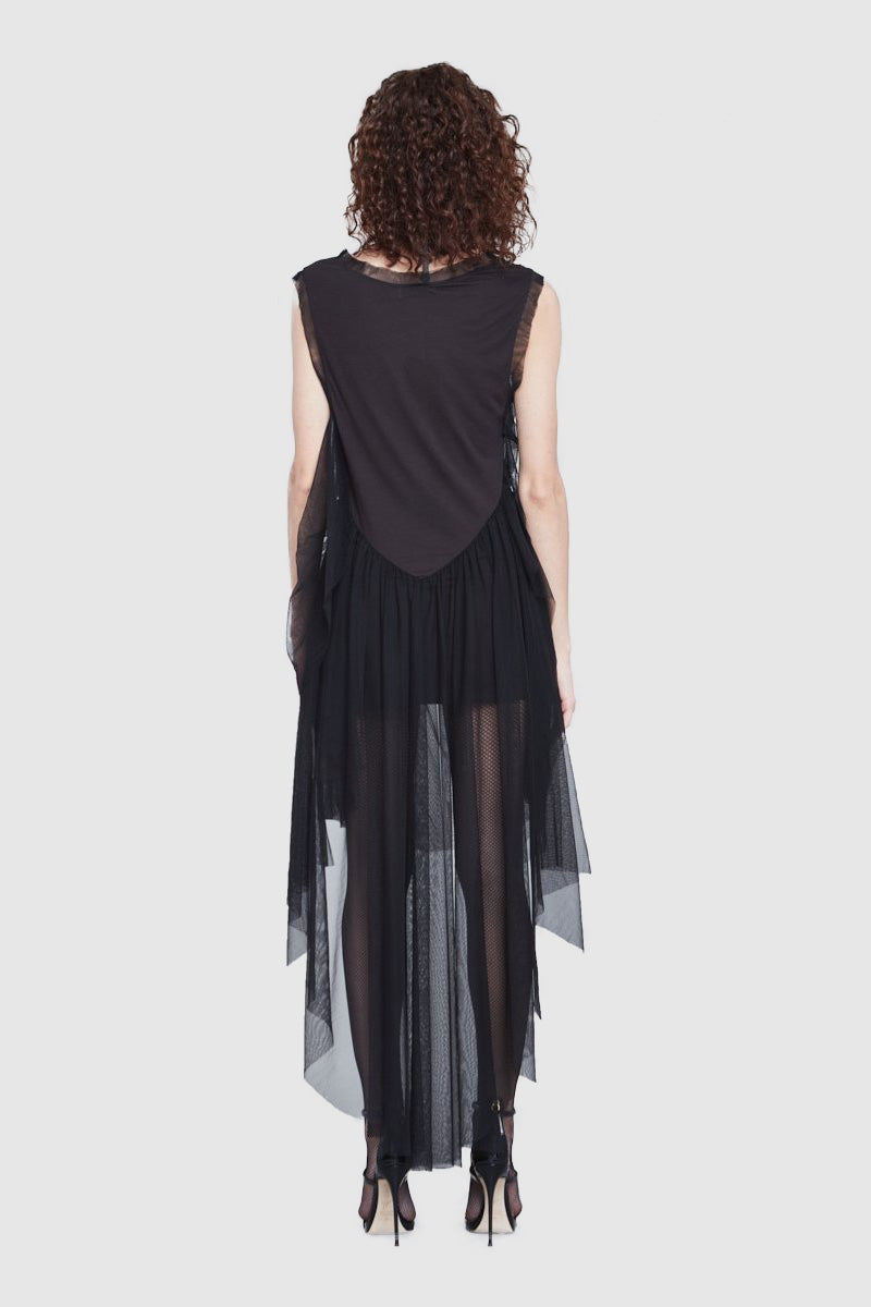 Back of the dress. A woman is wearing a black embroidered drap dress by Faith Connexion, a brand of luxury clothes