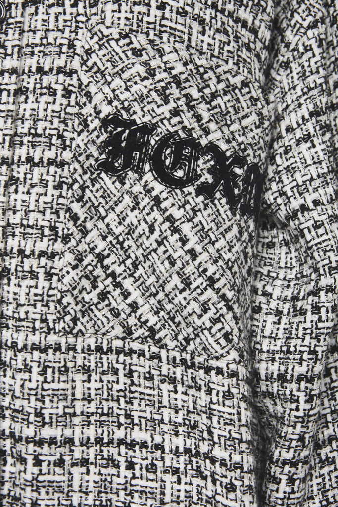A close-up of a black and white checked tweed shirt by Faith Connexion, a brand of luxury clothes