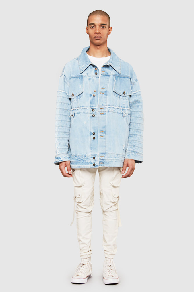 A man is wearing a reconstructed denim jacket by Faith Connexion, a brand of luxury clothes